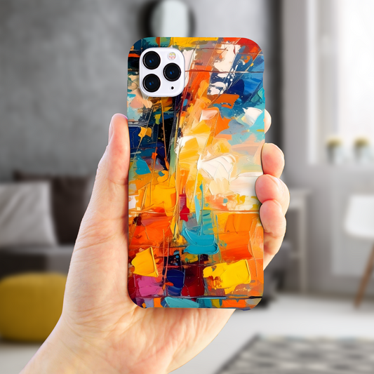 Hand holding a phone with a colorful abstract design case in a blurred indoor setting